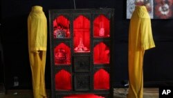 In this Saturday, Aug. 24, 2019 photo, burqas are on display at the Zan TV office in Kabul, Afghanistan. (AP Photo/Rafiq Maqbool)