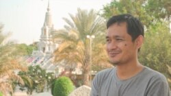 Ty Reaksmey, staff at a firm in Phnom Penh, takes part in the national blessing ceremony with his family at Wat Kol Tor Teng, in Phnom Penh, Cambodia, Monday, March 23, 2020. (Khan Sokummono/VOA Khmer)
