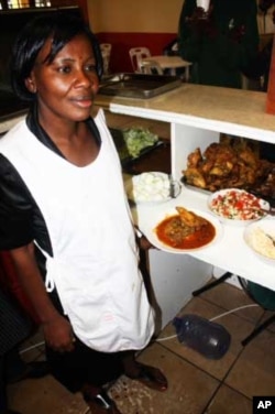 Nana Owusu, a cook at Uncle Ben's restaurant, is preparing to serve traditional African food to World Cup soccer supporters