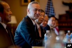 FILE - Chinese Vice Premier Liu He, center, accompanied by other Chinese officials, begins talks with U.S. Trade Representative Robert Lighthizer at the Executive Office Building on the White House Complex, Jan. 30, 2019.