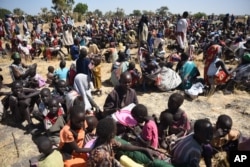 Some of more than 30,000 people who flocked into Leer town, South Sudan, to receive food from the International Committee of the Red Cross, Dec. 15, 2015, which marks the two-year anniversary of South Sudan's civil war.
