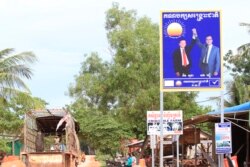 រូបឯកសារ៖ ស្លាក​សញ្ញា​គណបក្ស​សង្រ្គោះ​ជាតិ​នៅ​ក្នុង​ក្រុង​សៀមរាប​ ដែល​មានលោក សម រង្ស៊ី និងលោក កឹម សុខា។ (ស៊ុន ណារិន/វីអូអេ)