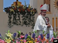 FILE - Osornos Bishop Juan Barros smiles as he leaves the altar after a Mass celebrated by Pope Francis on Lobito Beach in Iquique, Chile, Jan. 18, 2018.