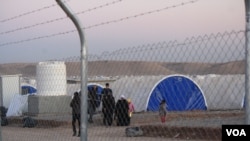 New families arrive at Hassan Sham camp say they fled to Iraqi Kurdistan regardless of IS death threats. They say militants said they would be killed if they didn't serve as human shields. (H.Murdock/VOA)