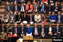 British Prime Minister Theresa May reacts during a no confidence debate after Parliament rejected her Brexit deal, in London, Britain, Jan. 16, 2019.