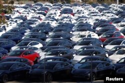 FILE - A parking lot of predominantly new Tesla Model 3 electric vehicles is seen in Richmond, Calif., June 22, 2018.