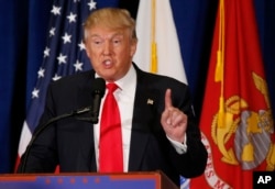FILE - Then-presidential candidate Donald Trump gestures during a speech in Virginia Beach, Virginia, July 11, 2016.