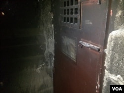 A cell door in what was once an ordinary home in Hamam Alil, Iraq on Dec. 7, 2016. (H.Murdock/VOA)