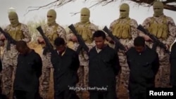 Islamic State millitants stand behind what are said to be Ethiopian Christians in Libya, in this still image from an undated video posted to a social media website on April 19, 2015.
