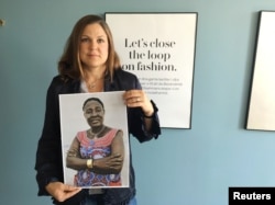 H&M Foundation Global Manager Diana Amini poses with portraits of women on its Foundation 500 list of female entrepreneurs in emerging markets in Stockholm, Sweden, June 2, 2017.