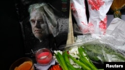 A memorial for movie actor Philip Seymour Hoffman is displayed in front of his apartment building in New York, Feb. 3, 2014.