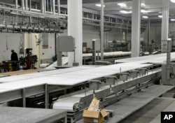 FILE - In this April 2, 2012 photo, employees continue work inside the Northern Beef Packers processing plant in Aberdeen, S.D., which raised construction money through the federal EB-5 investment-for-green-cards immigration program.