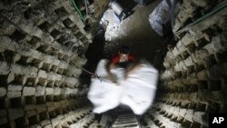 A Palestinian smuggler moves refrigerators through a tunnel from Egypt to the Gaza Strip under the border in Rafah, southern Gaza Strip, October 28, 2010.