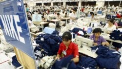 Vietnamese workers work at a sportswear production line for Nike at the Nha Be garment company in Ho Chi Minh City