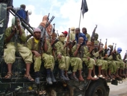 FILE - Al-Shabab fighters sit on a truck as they patrol in Mogadishu, Somalia,Oct. 30, 2009.
