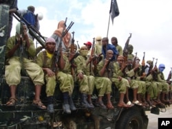 FILE - Al-Shabab fighters sit on a truck as they patrol in Mogadishu, Somalia,Oct. 30, 2009.