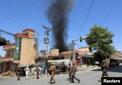 Smoke rises from an area where explosions and gunshots were heard, in Jalalabad city, Afghanistan, July 31, 2018.
