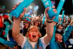 Supporters of Taiwan's ruling KMT or Nationalist Party presidential candidate Eric Chu cheer during a campaign rally in Taoyuan City, Taiwan, Sunday, Jan. 10, 2016.