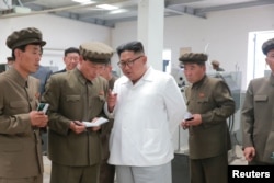 North Korean leader Kim Jong Un gives field guidance during his visit to a machine factory under the Ranam Coal Mining Machine Complex in this undated photo released by North Korea's Korean Central News Agency in Pyongyang, July 17, 2018.