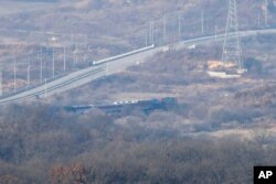 A train transporting dozens of South Korean officials runs on the rails which leads to North Korea, inside the demilitarized zone separating the two Koreas in Paju, South Korea, Nov. 30, 2018.
