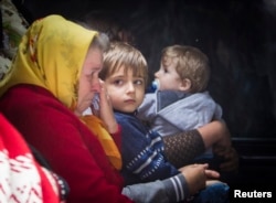 Civilians wait in a bus to flee from the eastern Ukrainian city of Slovyansk June 25, 2014.