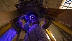 DART team members install and inspect the spacecraft’s DART's only instrument - the Didymos Reconnaissance and Asteroid Camera for Optical navigation (DRACO) - onto the spacecraft in June 2021. (Image Credit: NASA/Johns Hopkins APL/Ed Whitman)