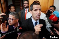 Venezuelan opposition leader and self-proclaimed interim president Juan Guaido talks to the media before a session of the Venezuela’s National Assembly, in Caracas, Venezuela, Jan. 29, 2019.