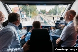 Officials ride the new Coradia iLint hydrogen-powered train that recently launched in northern Germany. (René Frampe/Alstom)