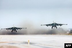 FILE - FILE - A handout picture taken on March 16, 2016, and released by the Russian Defense Ministry shows Russian Sukhoi Su-25 ground attack aircraft taking off from the Hmeimim military base in Latakia province, Syria.