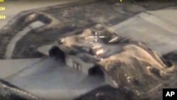 In this photo made from the footage taken from Russian Defense Ministry official website April 7, 2017, an aerial view shows shelters for aircraft at a Syrian air base after it was hit by U.S. strike in Syria.