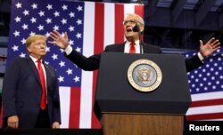 FILE - U.S. President Donald Trump listens at a rally in support of Rep. Kevin Cramer (R) in his run for Senate in Fargo, North Dakota, U.S., June 27, 2018.