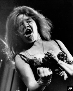 FILE - Singer Janis Joplin performs at the Newport Folk Festival with her band Big Brother and the Holding Company, July 29, 1968.