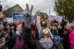 People take part in demonstration initiated by Polish mothers in front of the border guard office in Micholowo, Poland, to protest the deportation of migrants to Belarus, October 23, 2021.