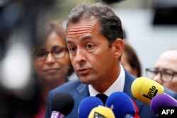 FILE - French essayist Hakim El Karoui speaks to journalists following a meeting with French Interior Minister and Islam representatives at the Interior Ministry, in Paris, Aug. 29, 2016.