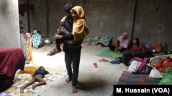 A sick Rohingya refugee is carried from one room to another in a Rohingya refugee camp in West Bengal, eastern India in April 2018. After receiving threats from the Hindu nationalists group in north India, where they lived for years since fleeing Myanmar, the refugees fled to eastern India in March.