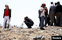 United Nations workers mourn their colleagues during a commemoration ceremony for the victims of the Ethiopian Airlines plane crash, near Addis Ababa, Ethiopia, March 15, 2019.