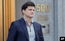 Gordon Caplan of Greenwich, Conn., walks out of federal court on March 12, 2019, in New York.