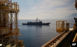 FILE - A Turkish Navy frigate escorts Turkey's new drillship 'Conquerer' off the coast of Antalya, southern Turkey.