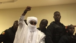 Chad's former dictator Hissene Habre raises his hand during court proceedings in Dakar, Senegal, May 30, 2016.