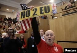 FILE - A demonstrator holds a pro-Brexit sign in central London, Britain, Jan. 13, 2018.