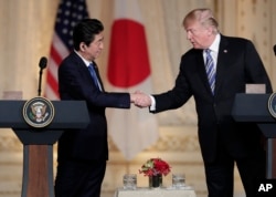 Japanese Prime Minister Shinzo Abe, left, and President Donald Trump shake hands during a news conference at Trump's private Mar-a-Lago club, April 18, 2018, in Palm Beach, Florida.