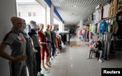 A vendor has her dinner in a mall on the Chinese side of the China-Kazakhstan Khorgos International Border Cooperation Center (ICBC), in Khorgos, China, May 12, 2017.