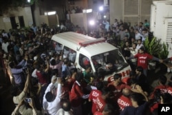 Volunteers of the Edhi Foundation escort the body of Pakistan's renowned social worker Abdul Sattar Edhi in an ambulance in Karachi, Pakistan, July 8, 2016.