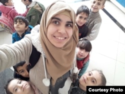 Shahira Qaddour smiles for a picture with the children in Selam Orphanage. (M. Qarra)