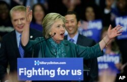 Democratic presidential candidate Hillary Clinton, center, speaks as Seattle Mayor Ed Murray, left, and his husband, Michael Shiosaki, right, look on Tuesday, March 22, 2016.