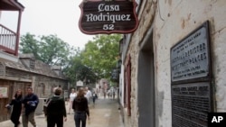 Visitors walk past the Casa Rodriguez, one of the oldest structures in St. Augustine.