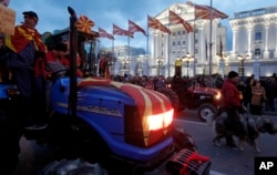 Farmers on tractors participate in a protest in front of the government building in Skopje, Macedonia, March 10, 2017. Thousands of ethnic Macedonians have held evening protests against three ethnic Albanian parties forming a coalition government with the Social Democrats.