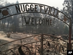 FILE - This Wednesday, Nov. 14, 2018 shows the remains of the Gold Nugget Museum, which was totally demolished by the Camp Fire, in Paradise, Calif. Paradise, Cali., literally went up in smoke in the deadliest, most destructive wildfire in California hist
