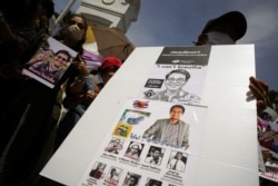Activists hold up pictures of abducted Thai activist Wanchalearm Satsaksit as people gather in support of him during a protest calling for an investigation, in front of the Government House in Bangkok, Thailand, June 12, 2020. (REUTERS/Athit Perawongmetha