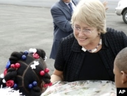 Michelle Bachelet is greeted by young children at Monrovia's Roberts International Airport on her first visit to Liberia in her new position.